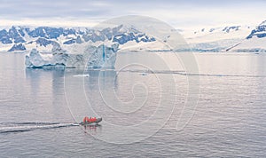 Expeditions - Zodiac with tourists cruises through Antarctic iceberg landscape at Portal Point