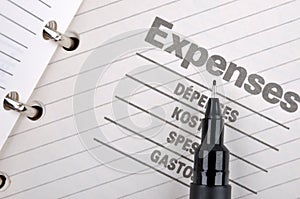 Expenses record and black pen