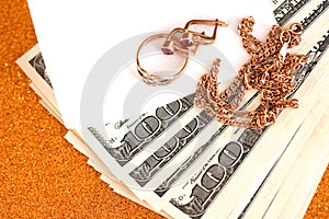 Expensive golden jewerly ring, earrings and necklace with big amount of US dollar bills on luxury glitter golden background
