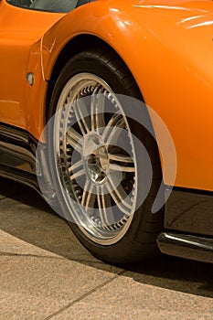 Expensive orange super car front tire