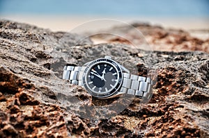 Expensive swiss wrist watch on a rock - Molokai, Hawaii