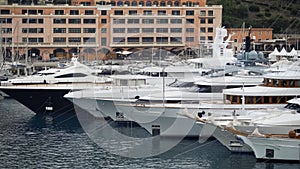 Expensive white yachts docked in harbor, luxury property of rich powerful people