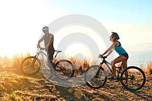 Experience the excitement with someone you love. Full length shot of a happy young couple out mountain biking together.