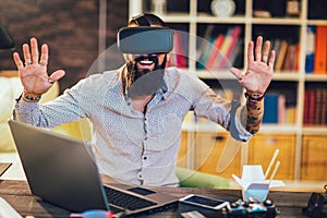 Experience With VR Headset . Man wearing virtual reality goggles working on urban design project