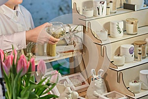 experienced artisan presents a meticulously crafted, handmade candle. Embracing Artisanal Traditions: The Resurgence of