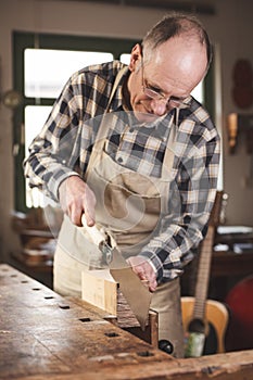 Experienced carpenter sawing with a Japanese hand saw