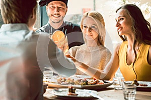 Experienced chef congratulated by four people at a trendy restaurant