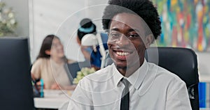 An experienced chief executive dressed in a shirt and tie prepares documents on the computer, sends messages to clients