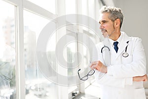 Experienced confident senior doctor with grey hair