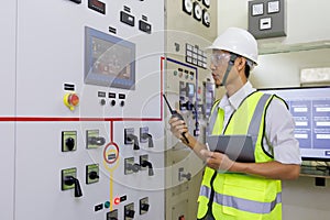 Experienced electrician working in power plant control room. Engineer working on the checking status switchgear electrical energy