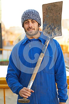 Experienced at excavation. Portrait of a construction worker with his shovel over his shoulder.