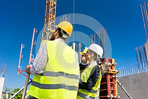 Experienced female architect or manager guiding the workers photo