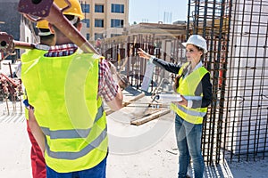 Experienced female foreman coordinating and guiding workers