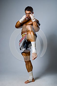 An experienced fighter kickboxer kick. full height