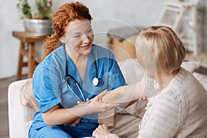 Experienced gentle private doctor testing patients joints