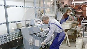 Experienced male glazier during daily work in glass factory