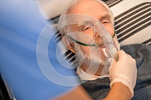 Experienced nurse conducting an oxygenation procedure on a bedridden man