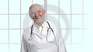 Experienced old senior doctor with stethoscope.