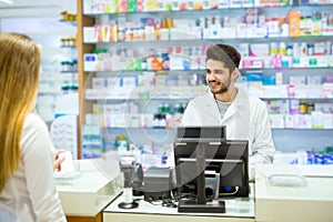 Experienced pharmacist counseling female customer in pharmacy