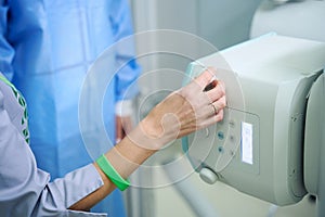 Experienced radiographer preparing person for radiographic examination