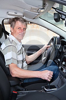 Experienced senior driver in car