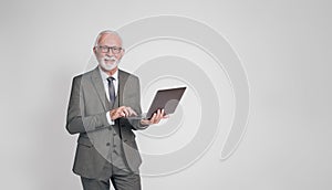 Experienced smiling male professional checking e-mails over laptop on isolated white background