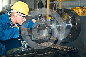 Experienced technicians Caucasian man are working by controlling steel lathes