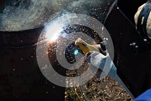 An experienced welder at work. Preparation and welding process of cast iron furnace. Selection focus. Shallow depth of field