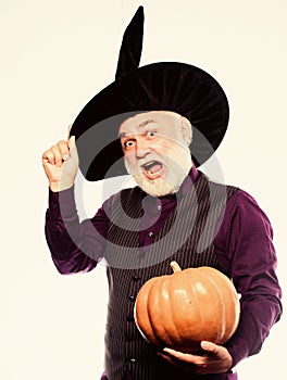 Experienced and wise. Halloween tradition. Cosplay outfit. Senior man white beard celebrate Halloween with pumpkin