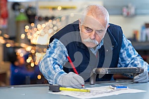 experienced worker crafting part at metalworks factory