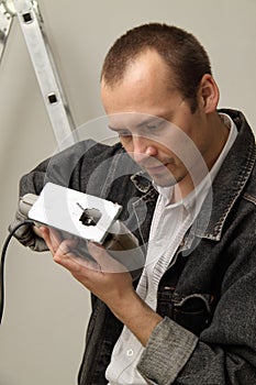 An experienced worker does his work with jigsaws