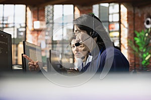 Experienced worker doing customer support job using PC to troubleshoot problems