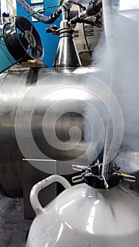 Experiment preparation in the cryogenics laboratory, filling up liquid nitrogen container photo