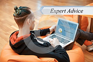 EXPERT ADVICE concept. A young man works at a computer