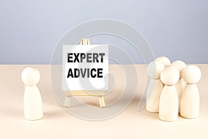EXPERT ADVICE text on easel with wooden figure, meeting concept