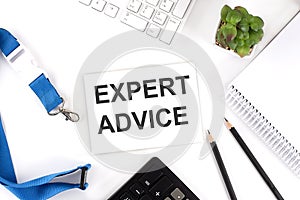 EXPERT ADVICE Words on the card with keyboard and office tools