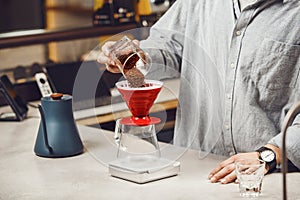 Expert Barista Prepares a V60 Pourover With Freshly Ground Coffee at Modern Coffee Shop, Close-up photo