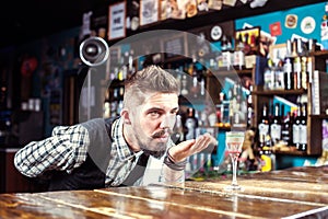 Expert barkeeper makes a show creating a cocktail in the pub