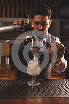 Expert bartender crafting a cocktail