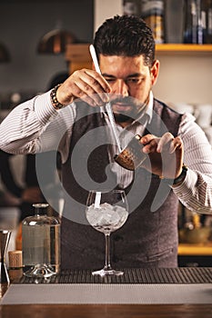 Expert bartender preparing a cocktail