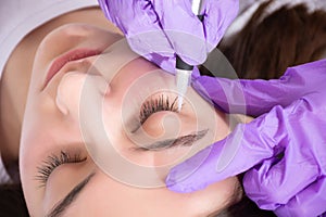 Expert Beautician Creating Permanent Eyeliner Tattoo