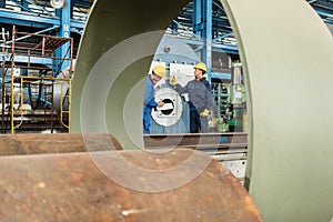 Expert checking the quality of manufactured boilers