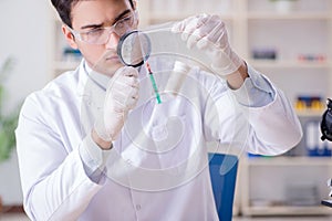 The expert criminologist working in the lab for evidence