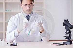 The expert criminologist working in the lab for evidence