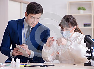 Expert criminologist working in the lab for evidence photo