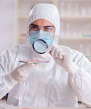 Expert criminologist working in the lab for evidence