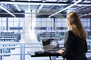 IT expert in data center updating AI systems, writing intricate binary code