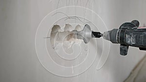 Expert electrician demonstrates precision drilling techniques with a rotary hammer and diamond core drill for socket