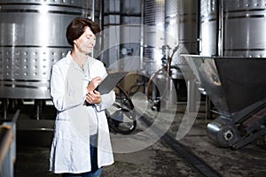 Expert examines equipment at winery