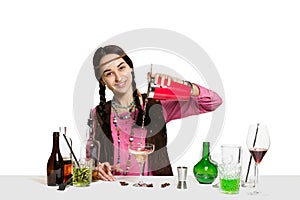 Expert female barman is making cocktail at studio